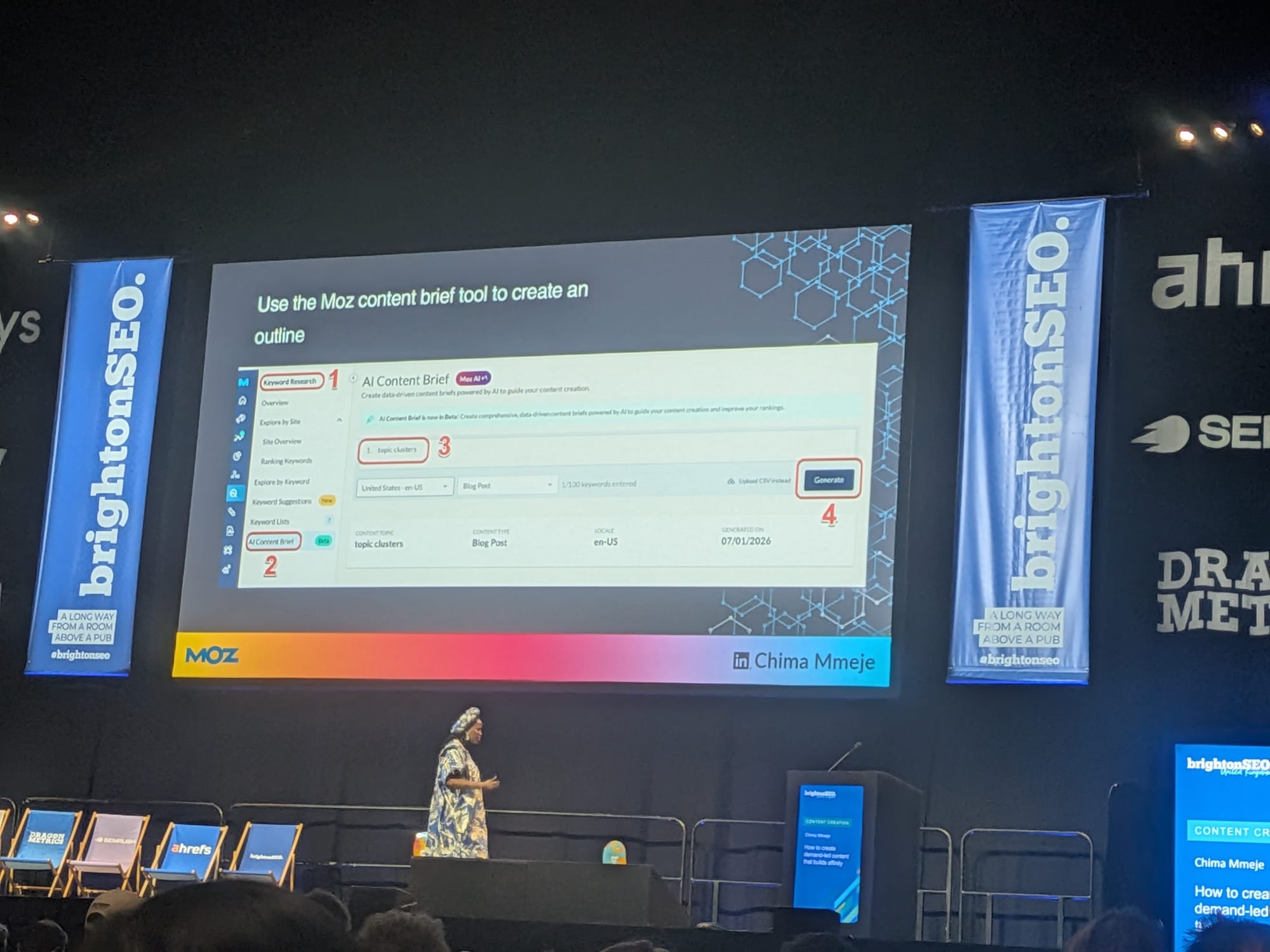 Chima MmejeのBrightonSEO 2026スライド「Moz AI Content Brief」ツールUI、4つの注釈ステップ: 1. 左ナビのKeyword Researchセクション、2. 左ナビのAI Content Brief、3. topic clustersキーワード入力欄、4. Generateボタン